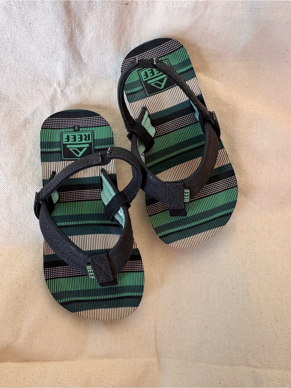 Reef Kids Black Strapped Flip-Flops with Green Striped Footbed